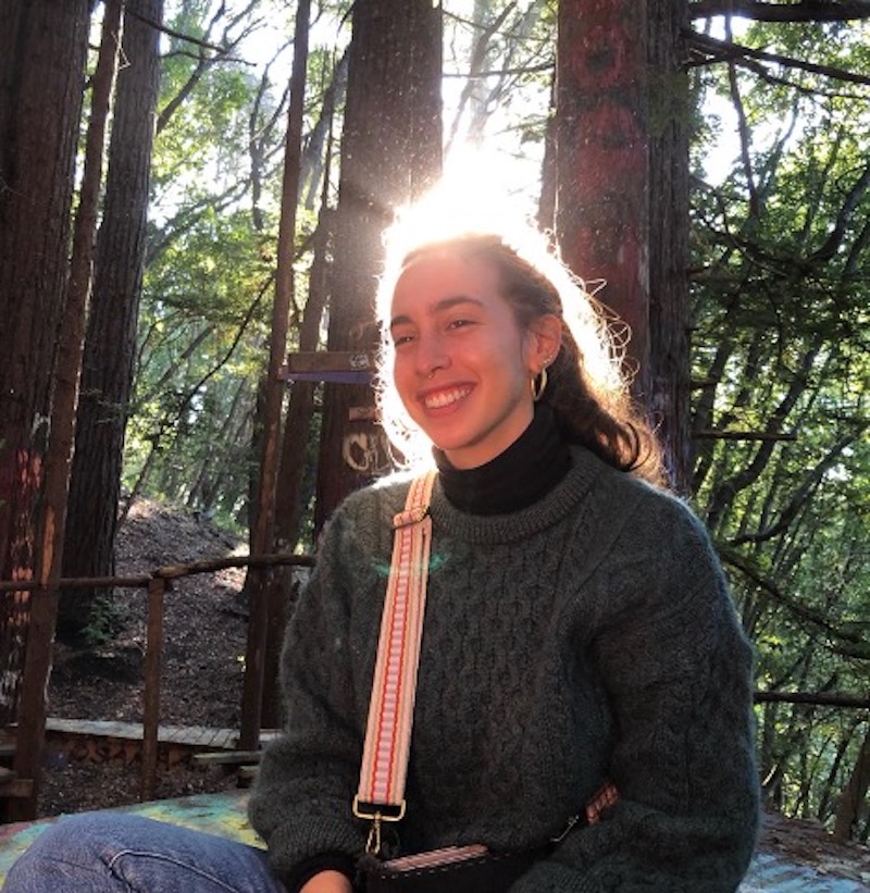 Jordanne Amber Greenberg posing for profile in sunny wooded area